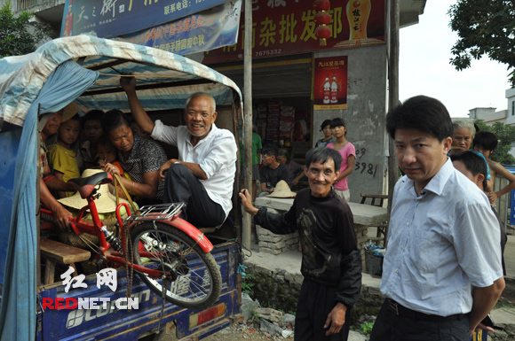 “停车！全下来！”7月4日清早，白沙镇。拦下违规载客的农用三轮，何录春（右）面色阴沉，司机（中）和搭车的村民却满不在乎。